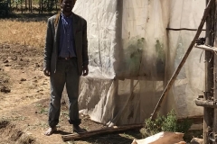 Hebtamu with his farm greenhouse